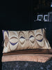 Modern decorative cushion with linen fabric and artisan details.
