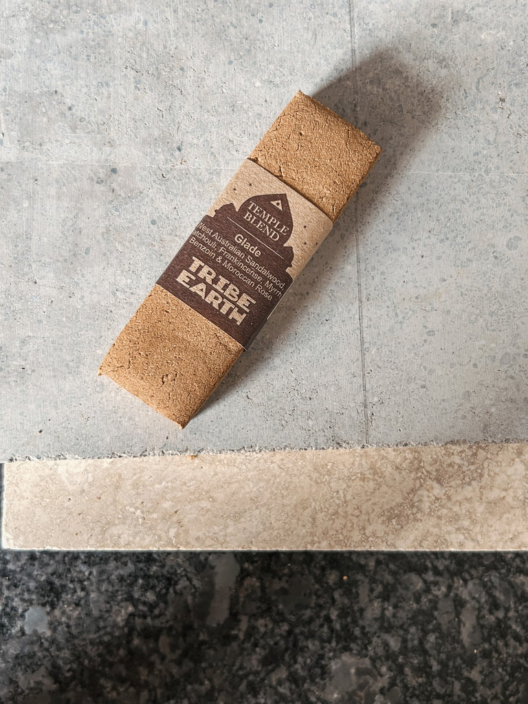 A handmade incense stick crafted from West Australian sandalwood, patchouli, frankincense, myrrh, benzoin, and Moroccan rose by Tribe Earth.