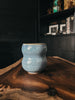 A hand-crafted ceramic mug in rutile blue, featuring a speckled design and a glossy finish.