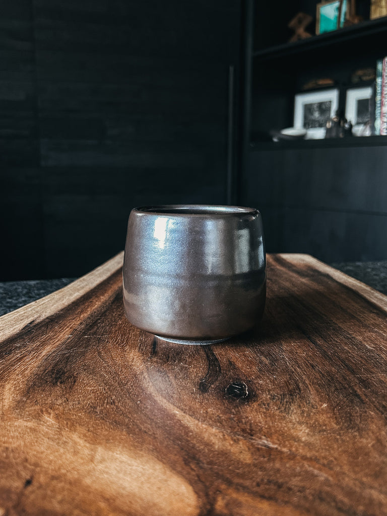 The handcrafted Holland Cup by Fenway Clayworks in the color Onyx.