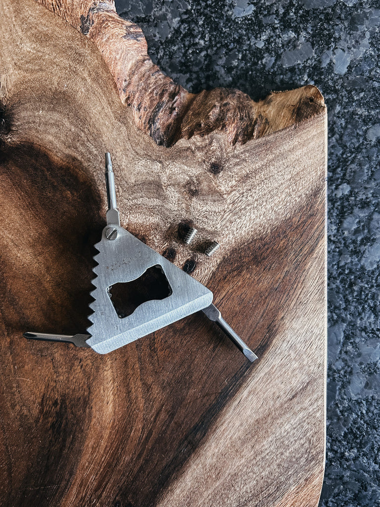 A universal surfboard key and screwdriver designed to fit FCS fins, Futures fins, single fin boxes, and SUP or longboard center fin screws.