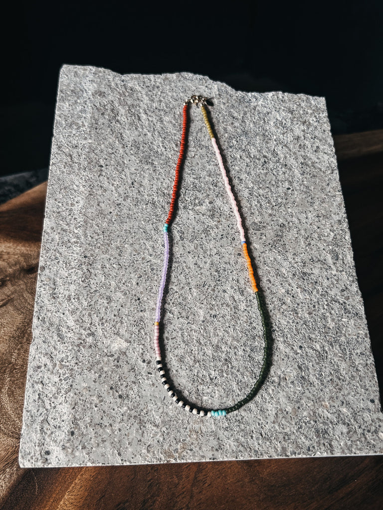 Rangi choker necklace featuring Japanese glass beads and gold clasp.