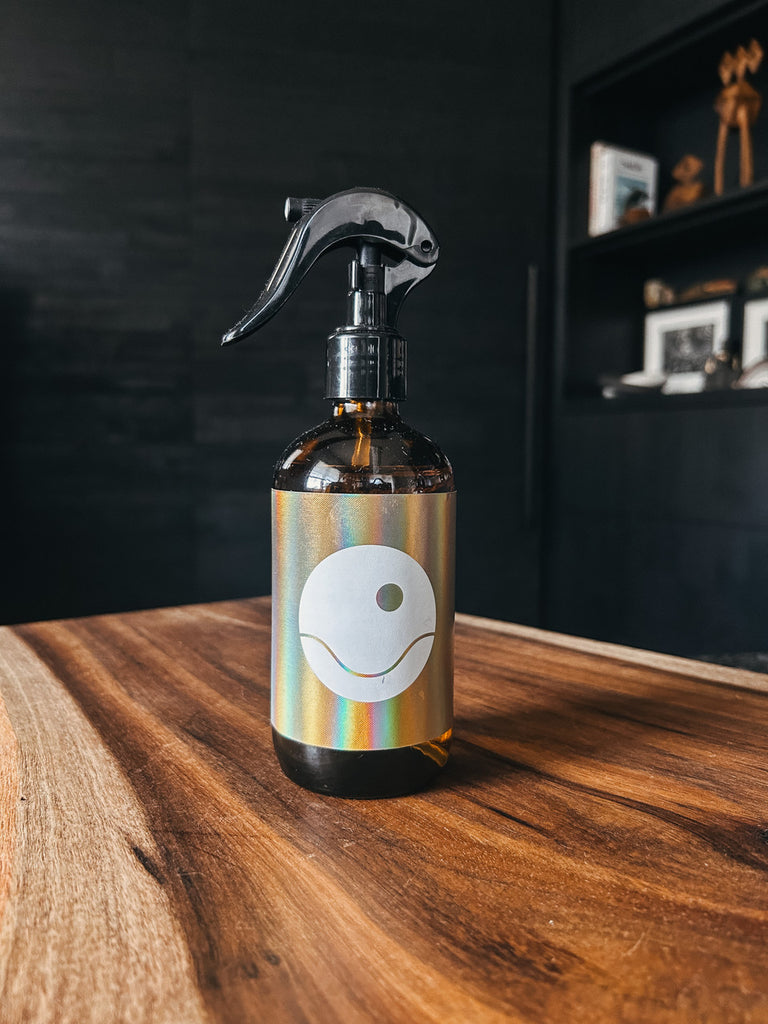 Glass bottle of Rituel mist spray by Studio Cuela, featuring a blend of Hiba wood and White Sage oils.
