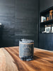 The Sandalo candle by Piedalu featuring notes of oak moss, sandalwood, patchouli, cedar wood, lily, and melon.