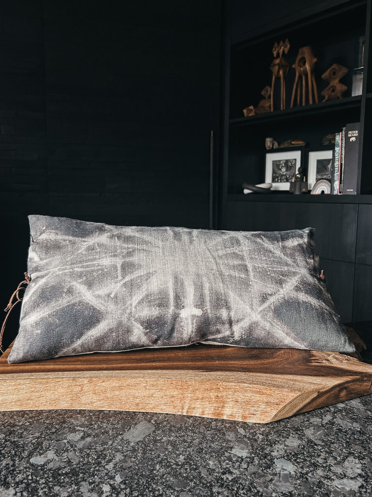 Handmade decorative pillow featuring a printed linen front, solid linen back, and leather tie closure.