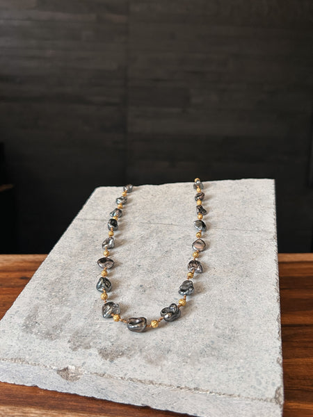 A necklace by Rainbow Gems Kauai, crafted from Keshi pearls and 18k gold.