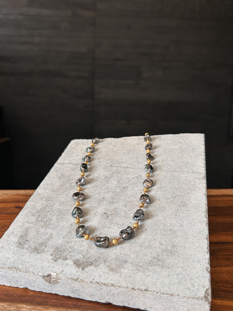 A necklace by Rainbow Gems Kauai, crafted from Keshi pearls and 18k gold.